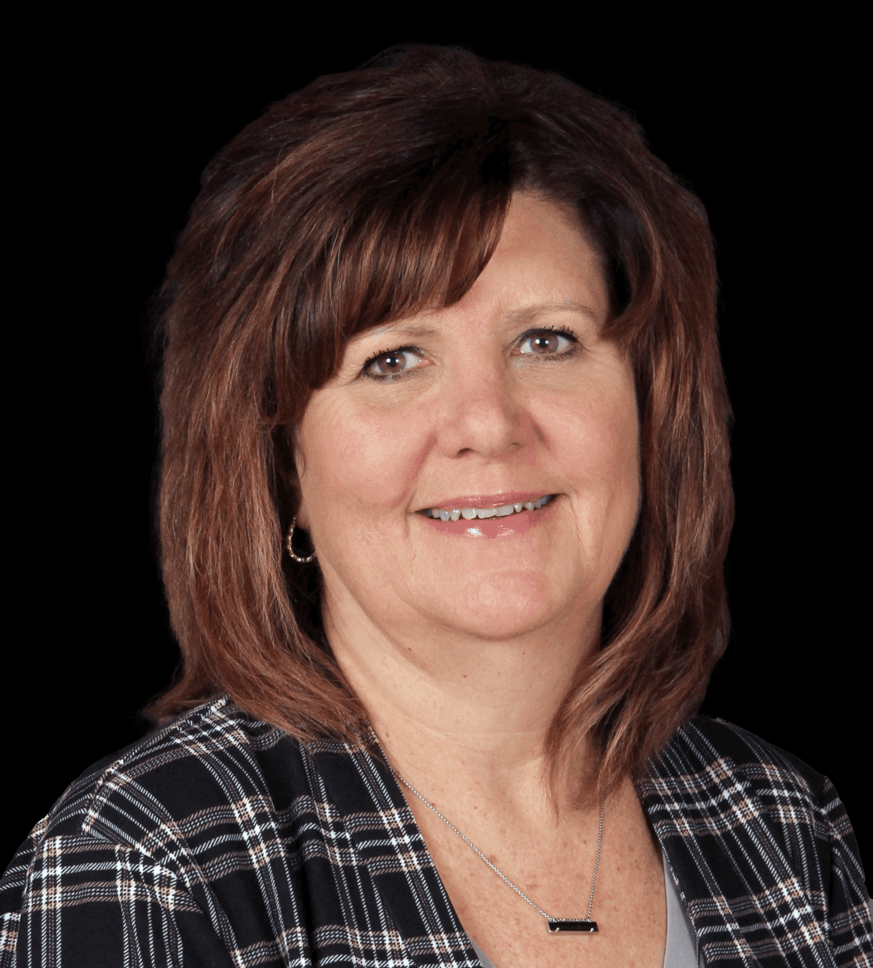 Crystal Packard parsons woman with medium length brown hair smiles at camera in front of a black background