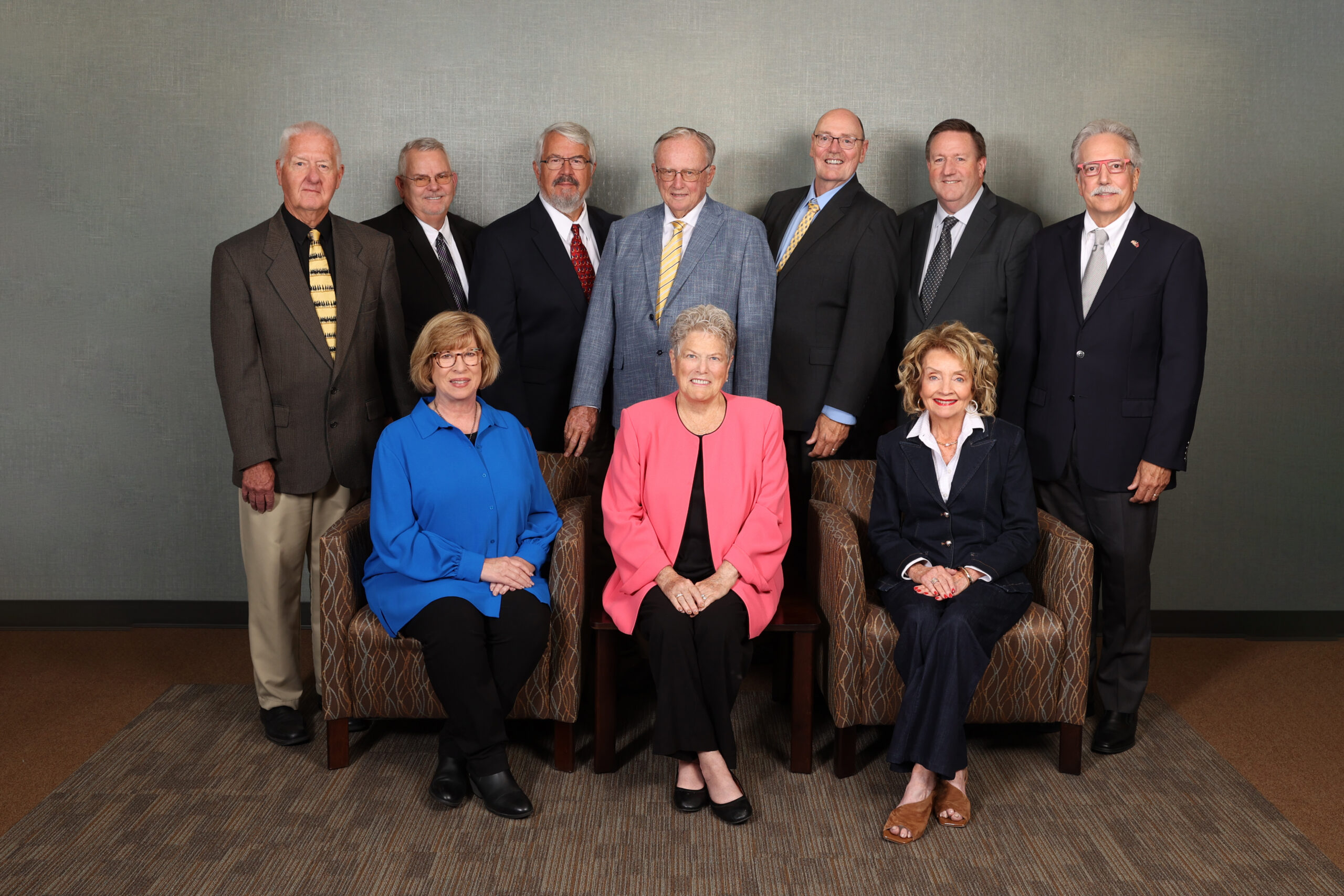 PMMA Board 2025 Photo of a group of people, three sitting in chairs, rest standing behind them. three women seven men
