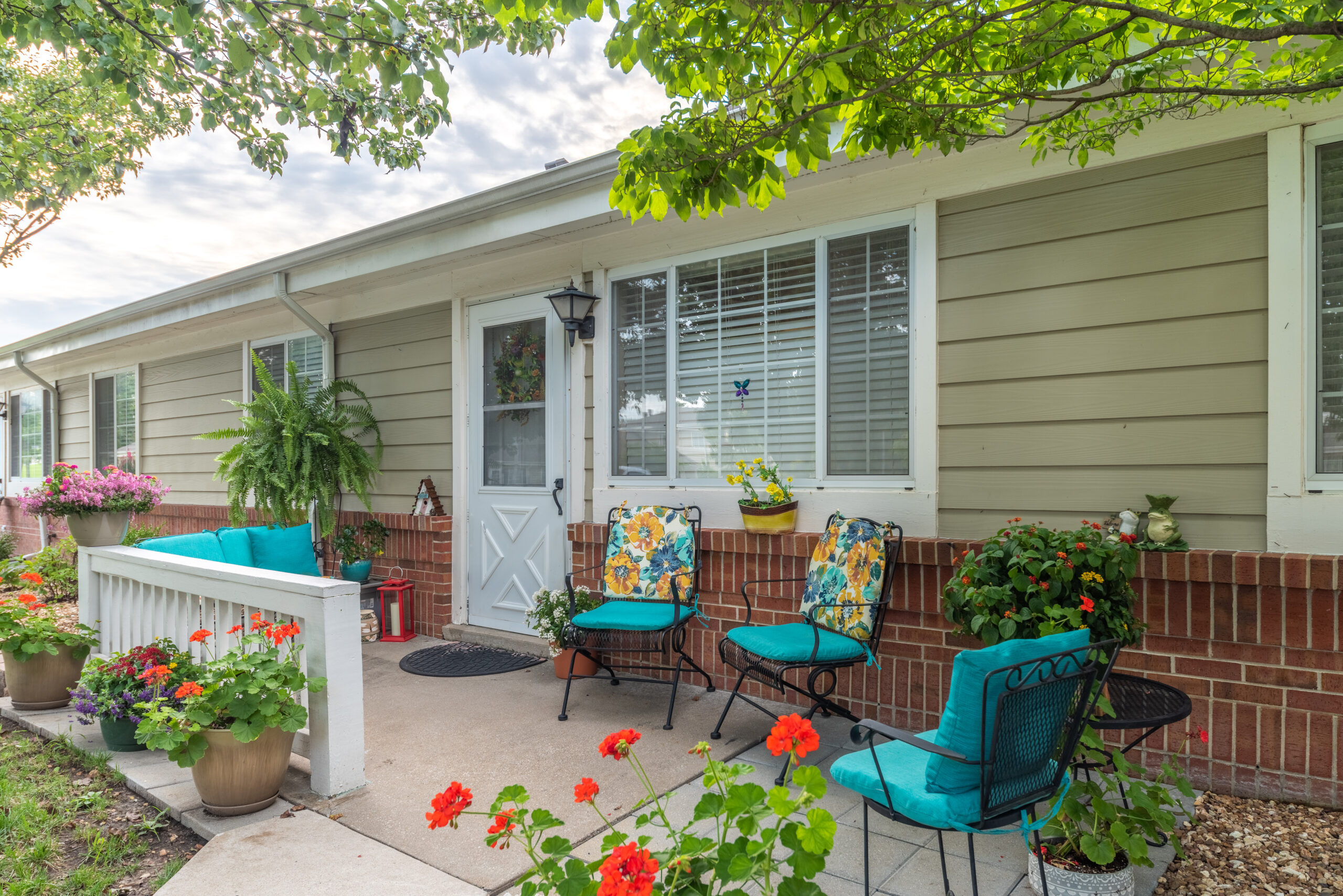 Photograhed by Rebekah Houser. FPSV apartment patio with chairs and flowers