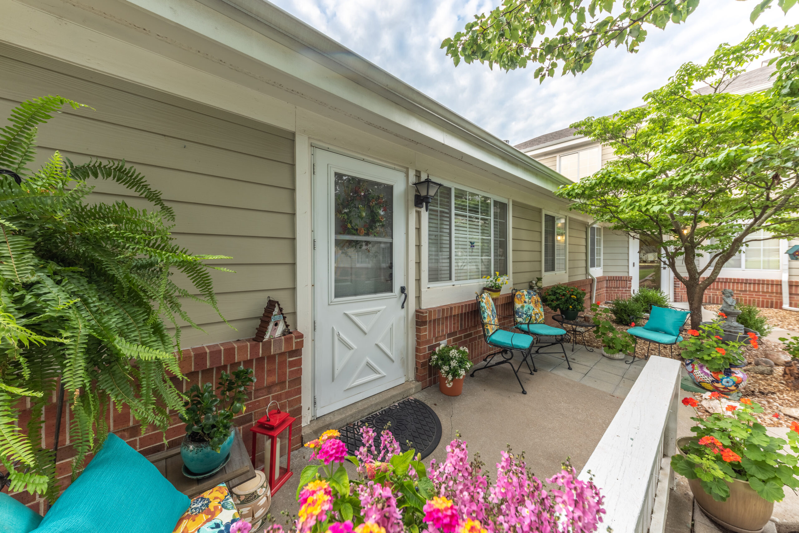 Photograhed by Rebekah Houser. FPSV apartment patio with chairs and flowers