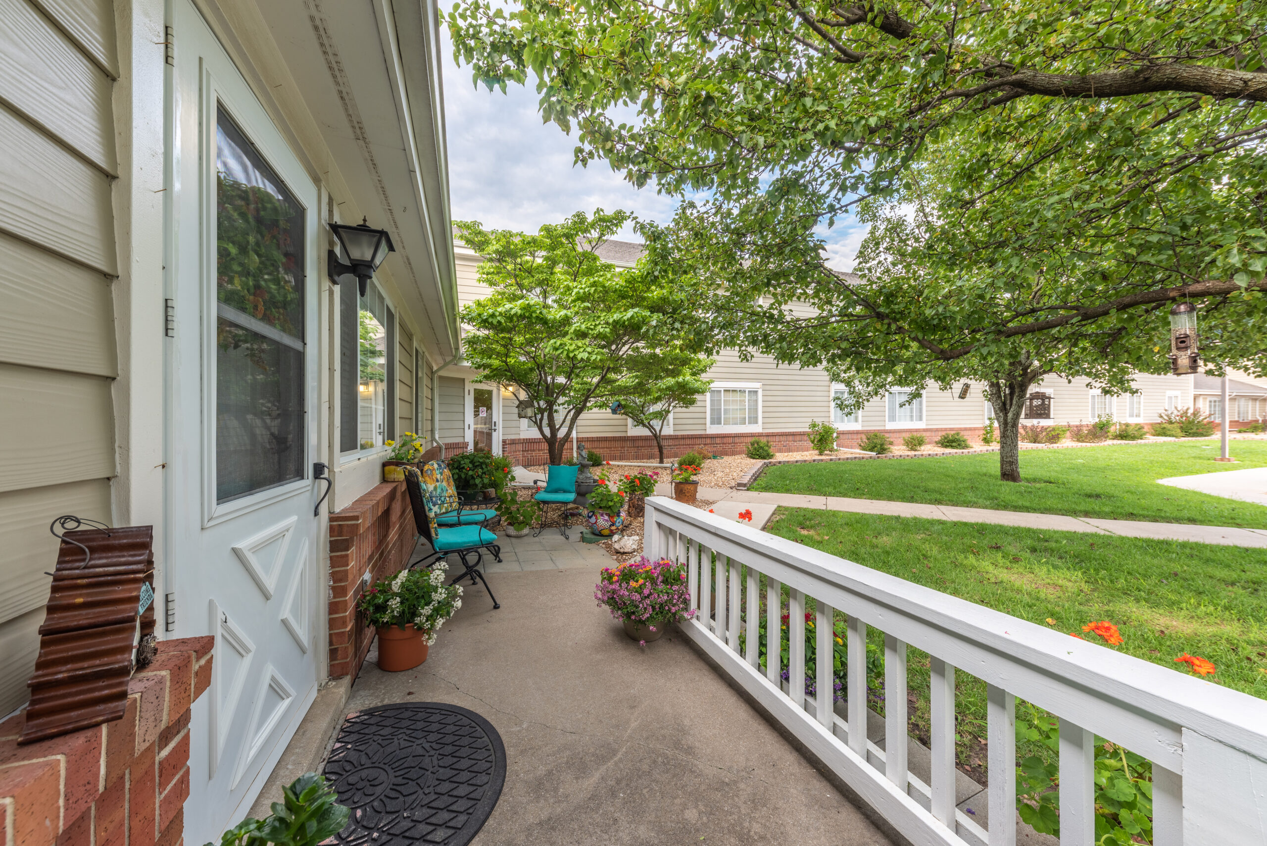 Photograhed by Rebekah Houser. FPSV apartment patio with chairs and flowers