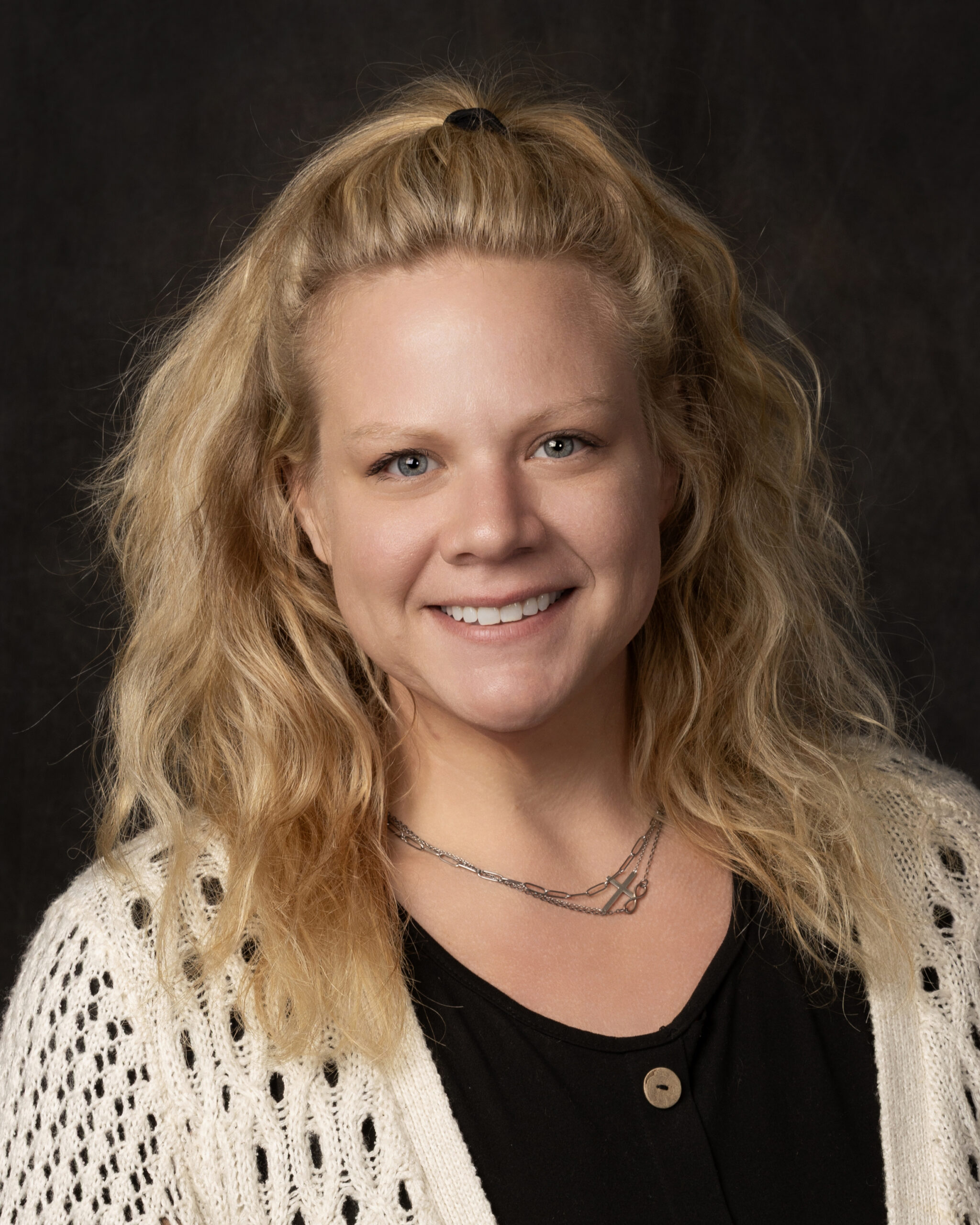 Woman with long blonde hair smiles into the camera